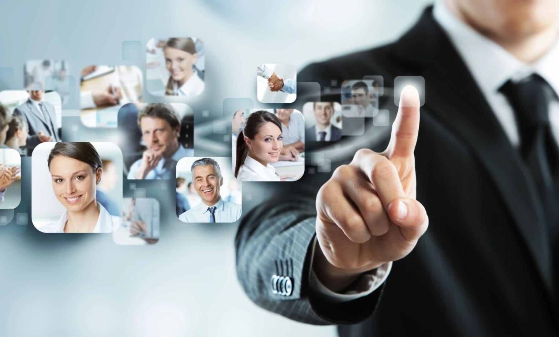 A man in business attire pointing to several images of people.